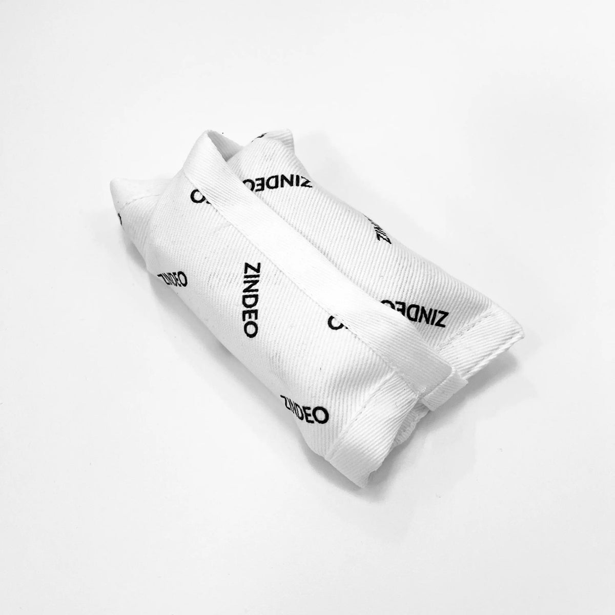 Closed white cotton drawstring pouch printed with the ZINDEO logo on a light background