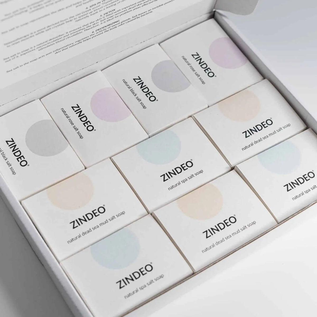 An open gift box filled with individually boxed ZINDEO natural salt soaps